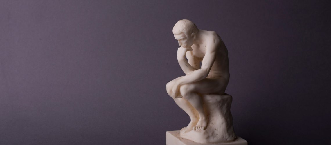 Rodin,Thinker,Statuette,Of,The,Naked,Man,On,The,Grey