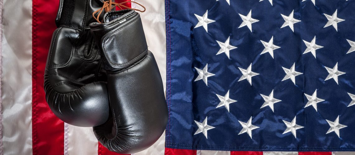 Boxing,Gloves,Hanging,In,Dramatic,Light,Against,The,American,Flag